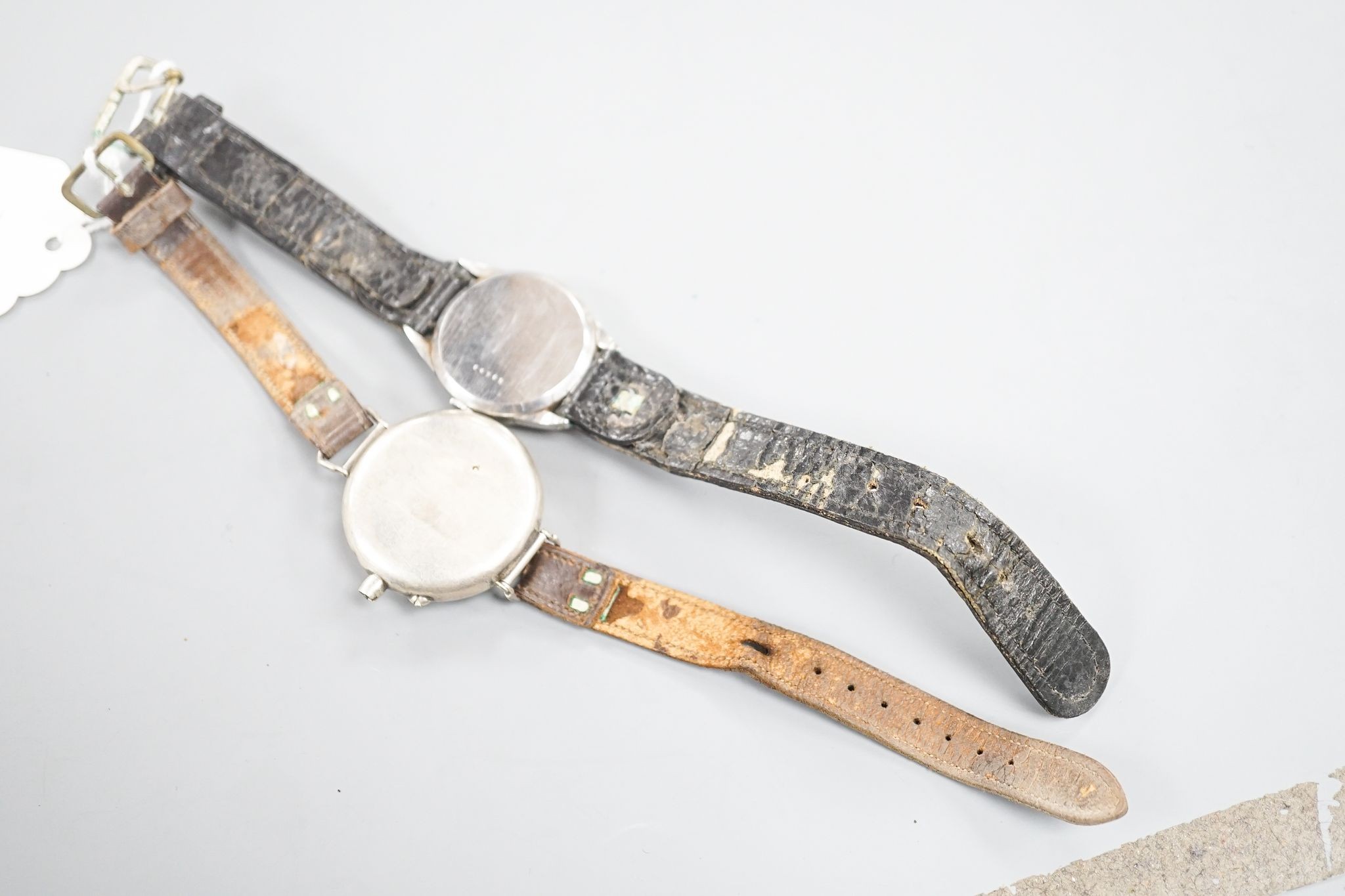 A gentleman's stainless steel Jaeger LeCoultre manual wind wrist watch, case back numbered 64765, on associated strap and a white metal fob watch, now mounted as a wrist watch(a.f.).